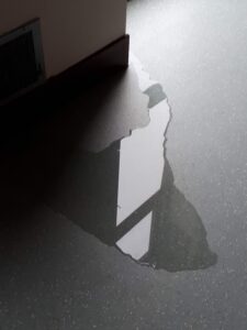 water puddle on floor inside near door