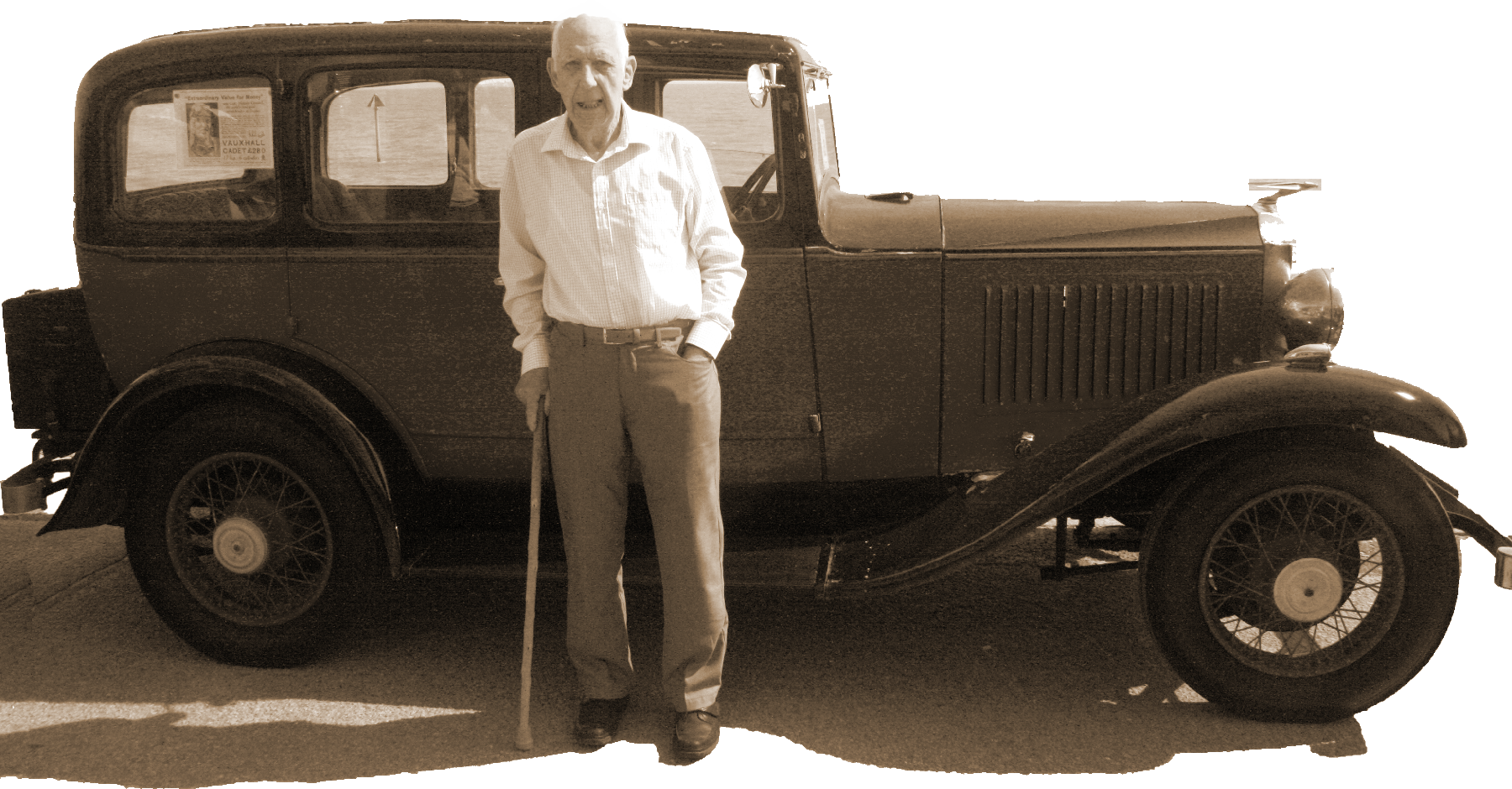 A man by the side of a 1930s car